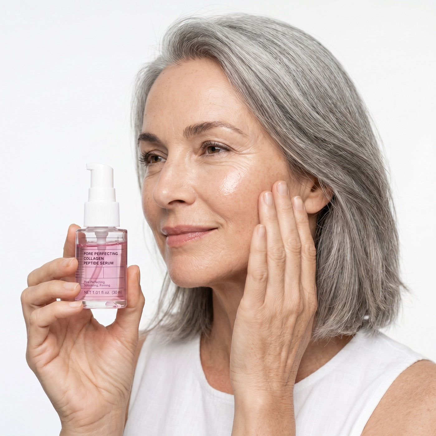 Woman applying Lumavay collagen peptide serum to her cheek